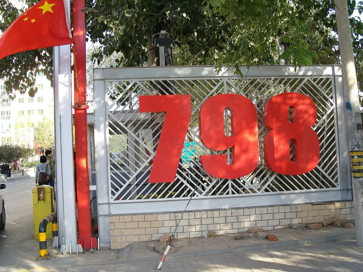 The red 798 sign on the steel lattice gate at the entrance to the 798 Art District