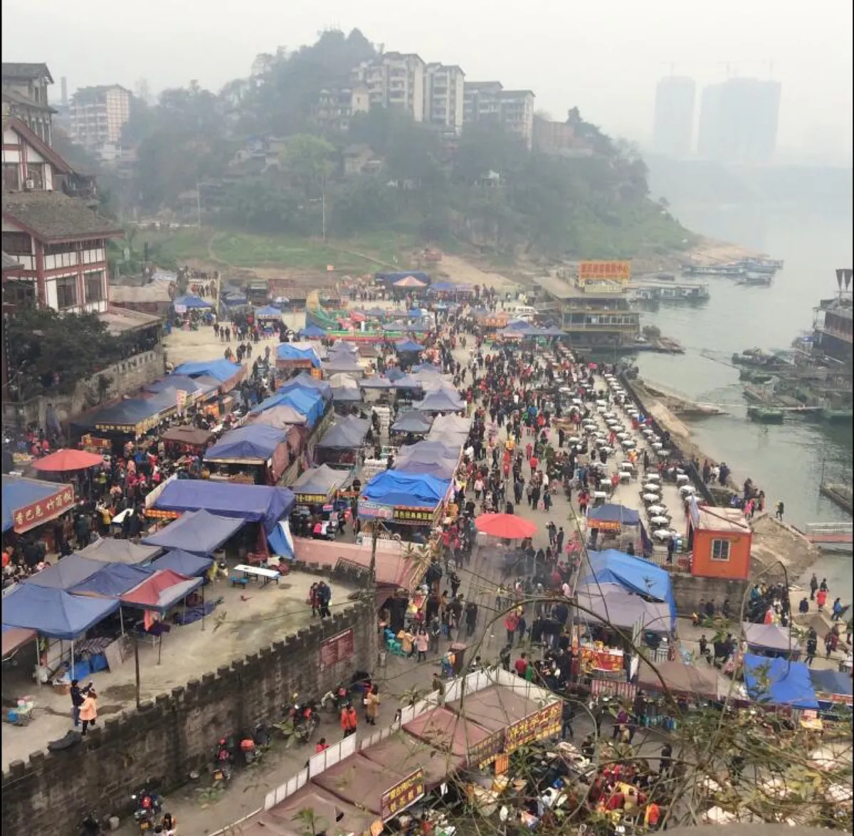 Crowds browsing riverside food stalls at Ciqikou Ancient Town in Chongqing