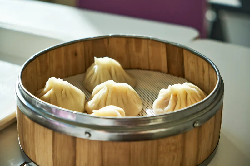 Steamed soup dumplings in a bamboo basket