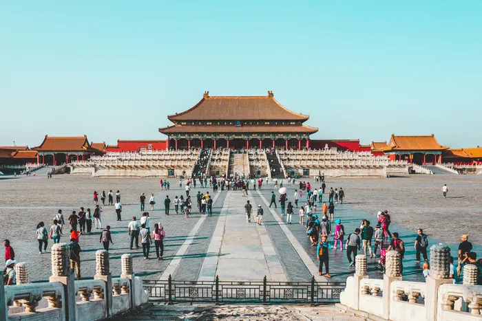 Crowds crossing the vast main courtyard of the Forbidden City toward the Hall of Supreme Harmony