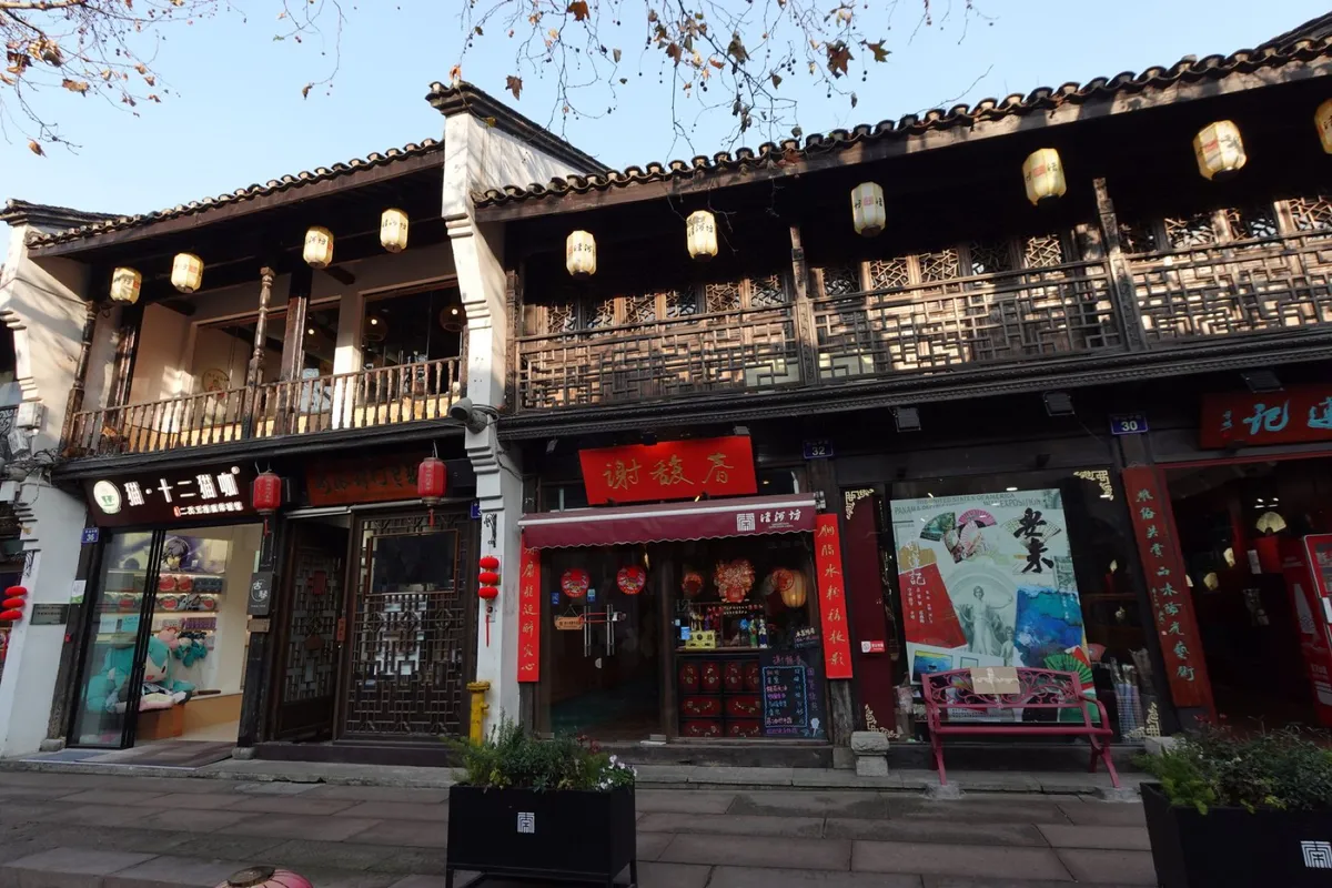 A traditional two-story shopfront with red lanterns along Hefang Street in Hangzhou