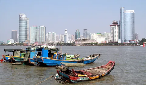 Fishing boats in the foreground with the Xiamen skyline across the water from Gulangyu Island