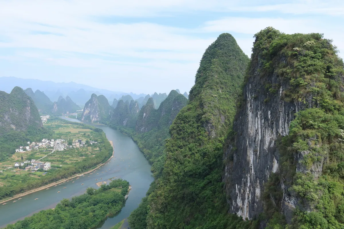Karst peaks reflected in the still water of the Li River near Guilin