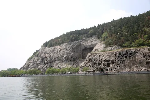Buddhist grottoes carved into the limestone cliffs of Longmen Grottoes above the Yi River