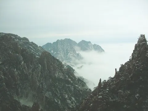 Snow-dusted granite peaks of Huangshan rising above a sea of clouds