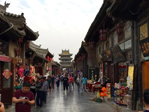 Pingyao's Ming-Qing street with red lanterns and the Market Tower in the distance