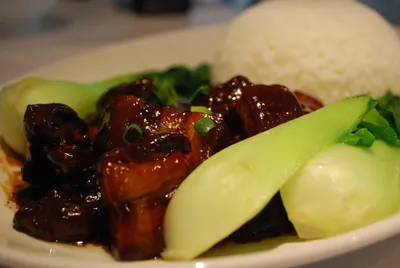 Glossy red-braised pork belly with bok choy and rice