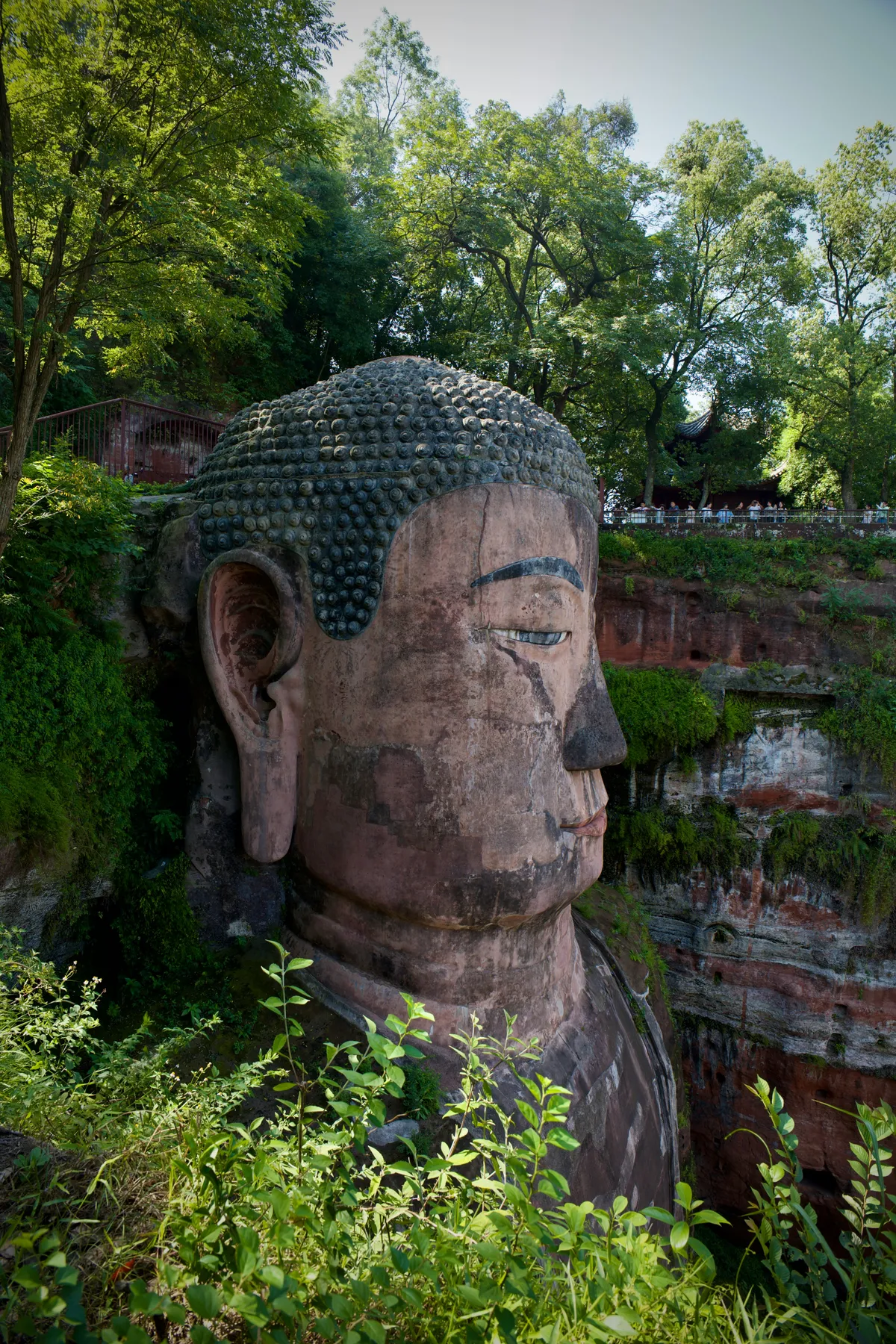 The Leshan Giant Buddha carved into a cliff face above the river