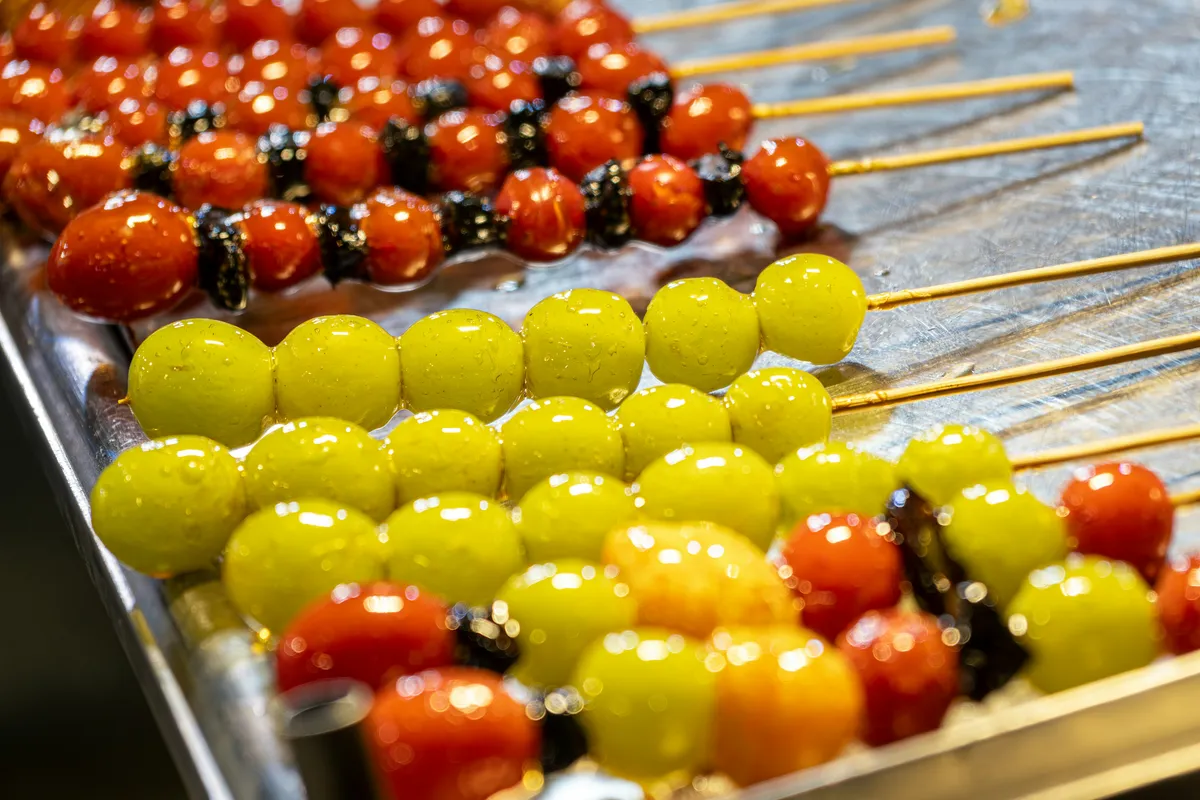A variety of Chinese street snacks laid out at a night market stall