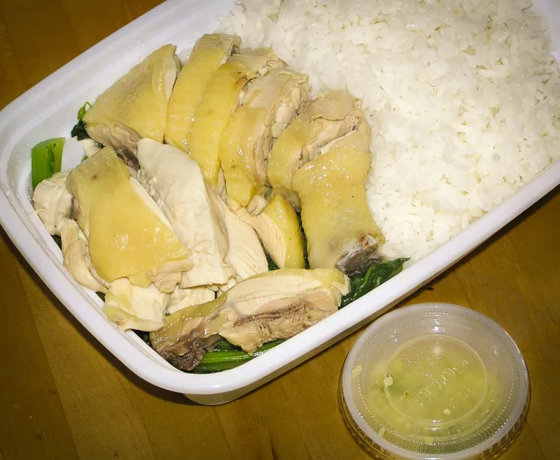 Sliced poached white cut chicken served with rice and a ginger dipping sauce