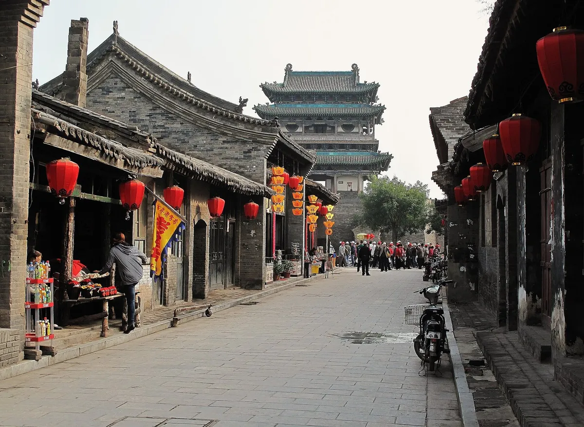 A lantern-lined street in Pingyao leading to the Yingxun Gate tower